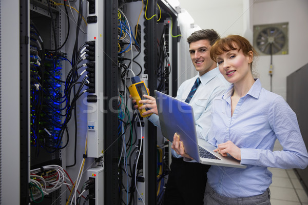 Team of technicians using digital cable analyser on servers Stock photo © wavebreak_media