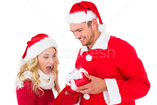 Festive young couple exchanging presents Stock photo © wavebreak_media
