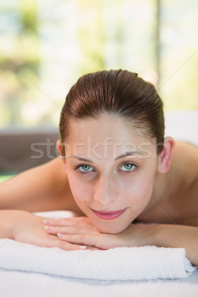 Stock photo: Beautiful woman lying on massage table at spa center
