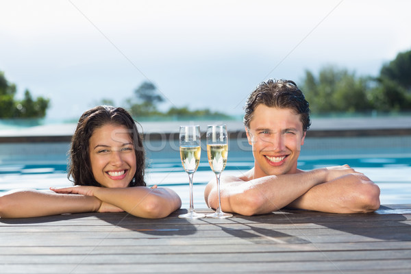 Cuplu şampanie flaute piscină portret Imagine de stoc © wavebreak_media