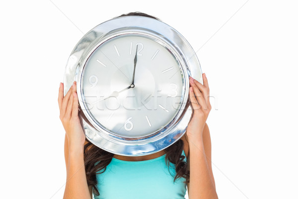 Pretty brunette holding a clock Stock photo © wavebreak_media