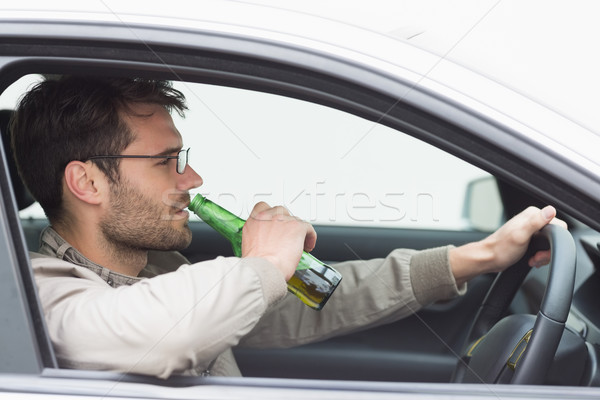 Man drinking beer while driving Stock photo © wavebreak_media