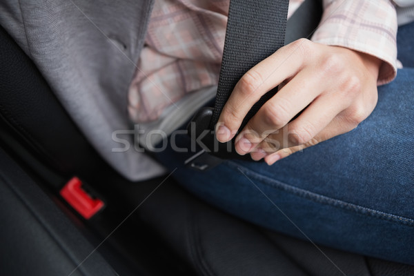 Woman putting on her seat belt Stock photo © wavebreak_media