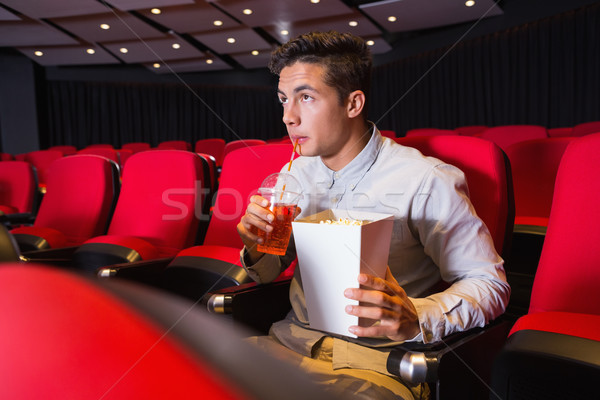 Young man watching a film Stock photo © wavebreak_media