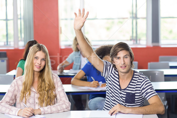 Male student raising hand in classroom Stock photo © wavebreak_media