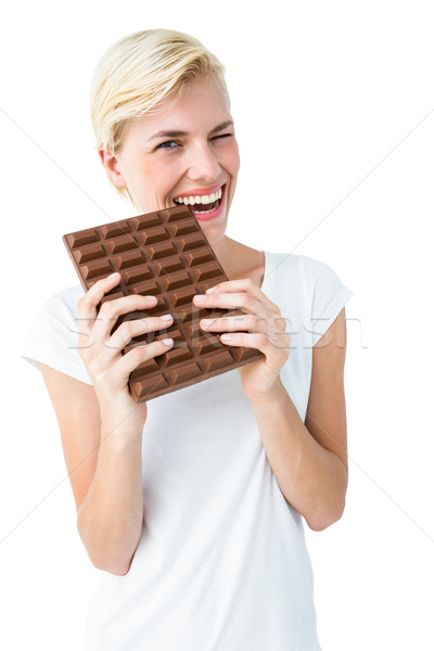 Attractive woman biting bar of chocolate Stock photo © wavebreak_media
