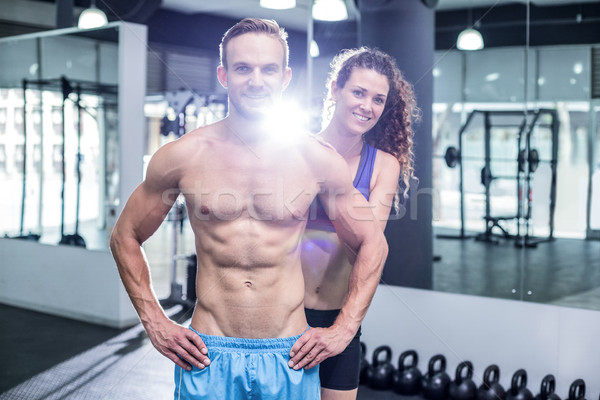Smiling muscular couple looking at the camera Stock photo © wavebreak_media
