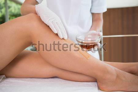 Therapist waxing womans leg at spa center Stock photo © wavebreak_media