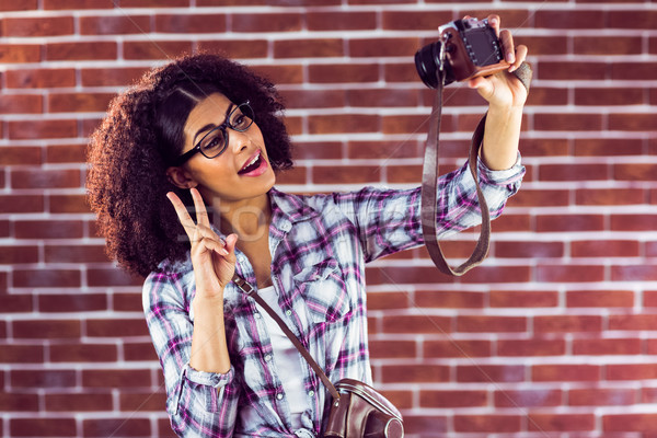 Attractive hipster taking selfies with camera Stock photo © wavebreak_media