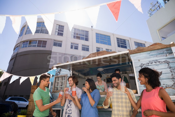 Friends interacting while having juice Stock photo © wavebreak_media