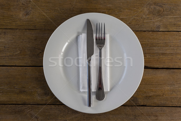 White plate with cutlery and napkin on table Stock photo © wavebreak_media