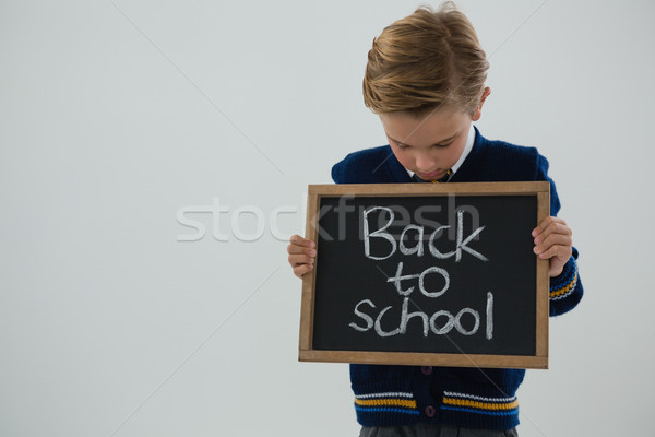 Iskolás fiú tart szöveg fehér imádnivaló férfi Stock fotó © wavebreak_media