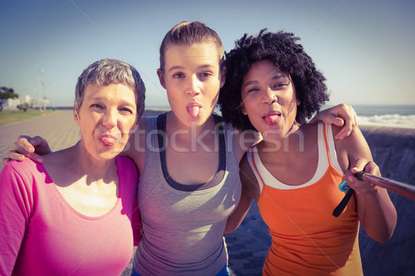 Sporty women posing and taking selfies with selfiestick  Stock photo © wavebreak_media