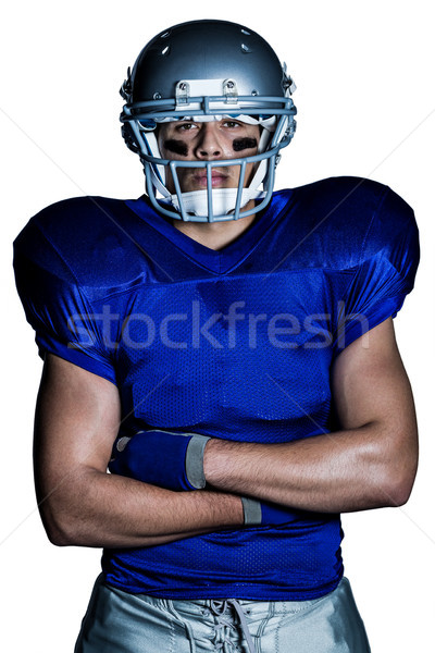Portrait of determined American football player with arms crosse Stock photo © wavebreak_media