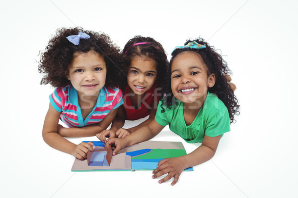 Three girls with a small book Stock photo © wavebreak_media