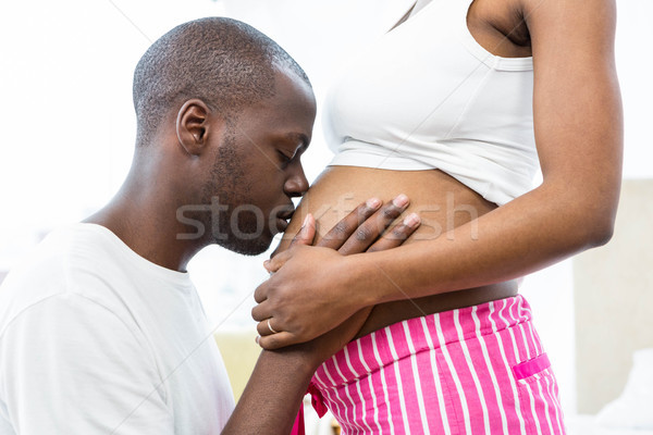 Człowiek całując ciąży brzuch sypialni domu Zdjęcia stock © wavebreak_media