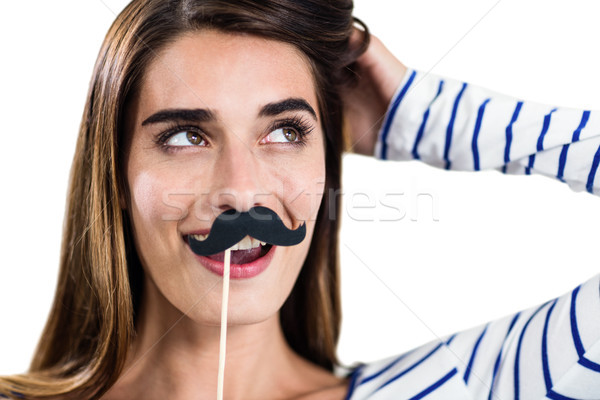 Smiling woman holding artificial mustache Stock photo © wavebreak_media