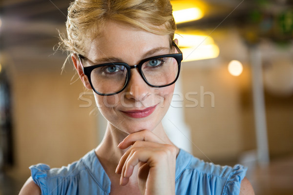 Stock photo: Beautiful woman in spectacle with hand on chin