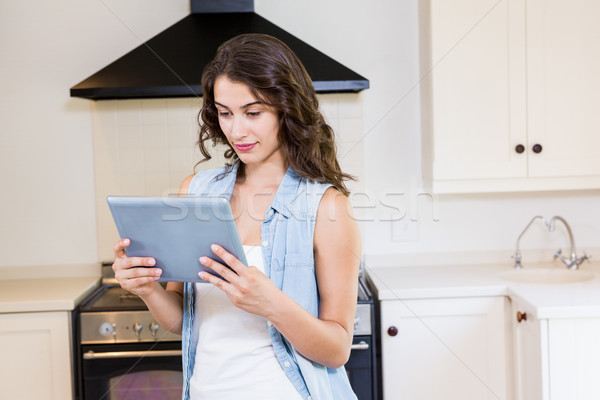 Young woman using digital tablet in kitchen Stock photo © wavebreak_media