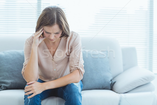 Tensed woman sitting on sofa Stock photo © wavebreak_media