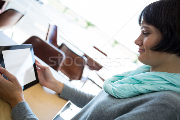 Smiling woman using digital tablet Stock photo © wavebreak_media