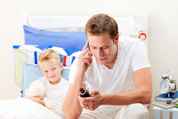 Attentive man looking after his sick son Stock photo © wavebreak_media