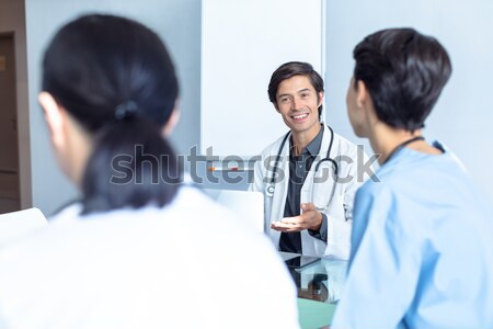 Handsome doctor talking with his patient for the annual check-up Stock photo © wavebreak_media