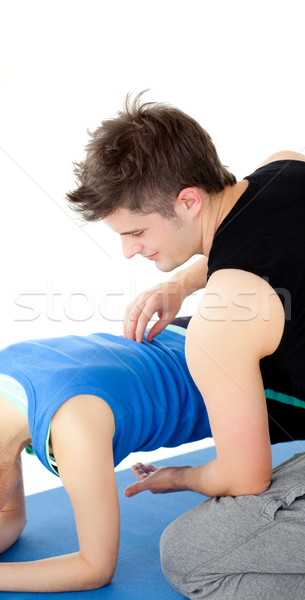 Caucasian woman working out assited by her personal trainer Stock photo © wavebreak_media