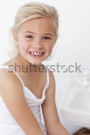 Cute little boy sitting at a table to eat a boiled egg in the kitchen Stock photo © wavebreak_media