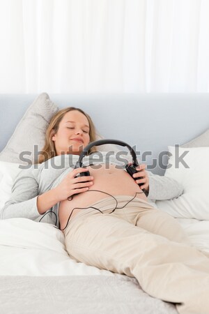Quiet woman enjoying some music in her bedroom Stock photo © wavebreak_media