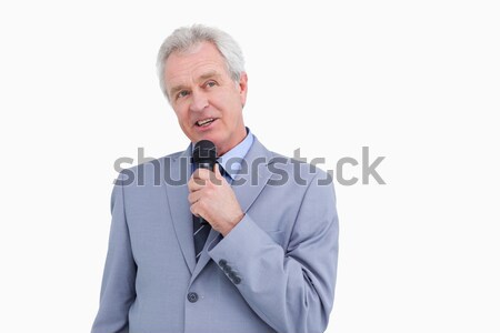 Mature tradesman with microphone against a white background Stock photo © wavebreak_media