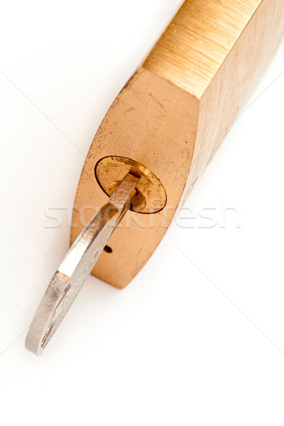 Stock photo: Key locked in padlock against white background