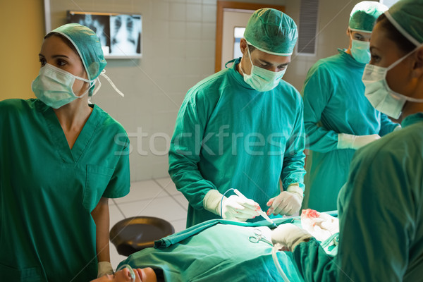 Team of surgeons working on the stomach of a patient Stock photo © wavebreak_media
