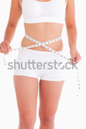 Midsection of fit woman measuring waist Stock photo © wavebreak_media