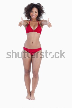 Composite image of fit happy girl in white bikini holding footba Stock photo © wavebreak_media