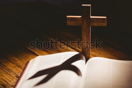 Open bible with crucifix icon behind Stock photo © wavebreak_media