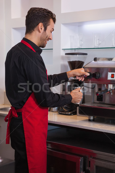 Boldog fiatal barista kancsó tej kávézó Stock fotó © wavebreak_media