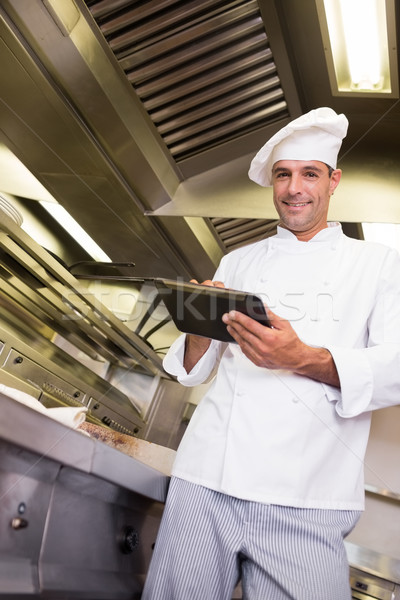Smiling male cook using digital tablet in kitchen Stock photo © wavebreak_media