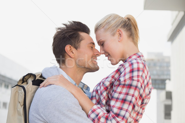 Stock photo: Hip young couple smiling at each other