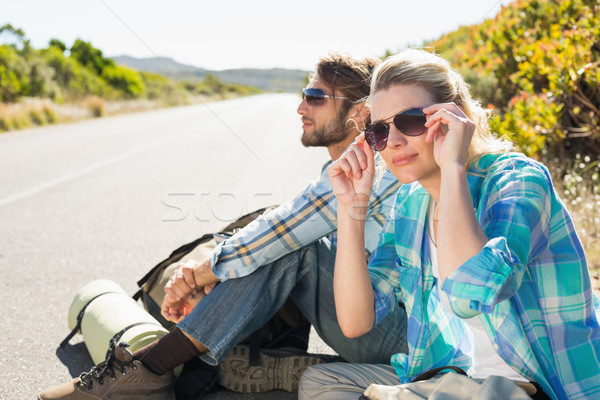 Attractive couple sitting on the road hitch hiking Stock photo © wavebreak_media