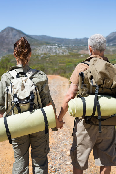 Randonnée couple permanent montagne sentier mains tenant [[stock_photo]] © wavebreak_media