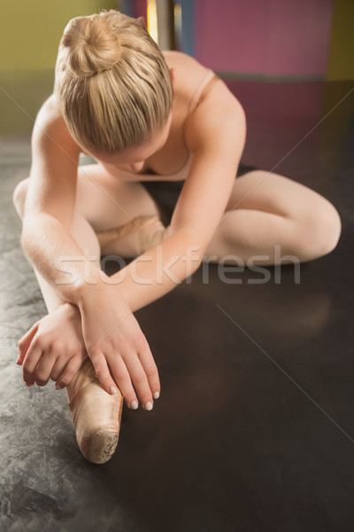 Ballerina sitting and bending forward Stock photo © wavebreak_media