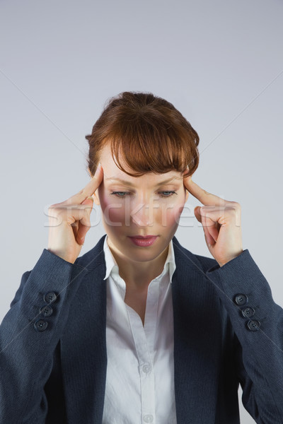 Stressed businesswoman getting a headache Stock photo © wavebreak_media