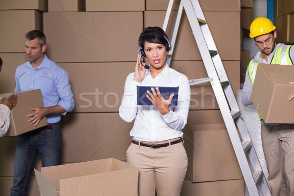 Pretty warehouse manager using tablet during busy period Stock photo © wavebreak_media