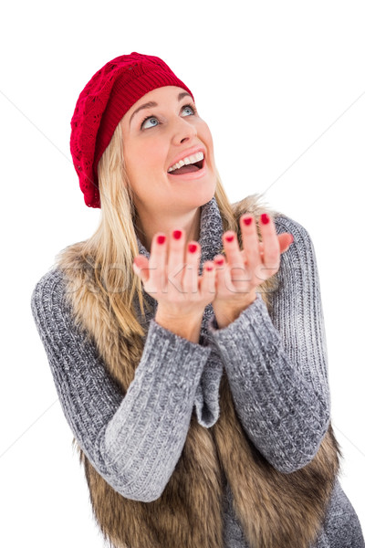 Blonde in winter clothes with hands out Stock photo © wavebreak_media