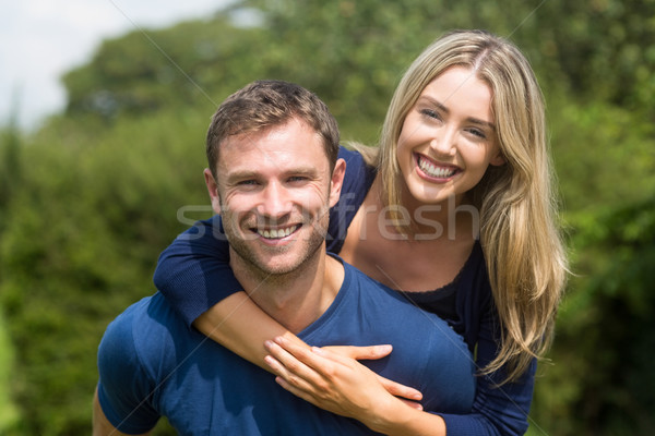 Cute couple smiling at camera Stock photo © wavebreak_media