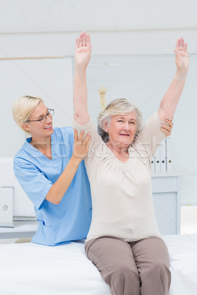 Nurse assisting female patient in exercising Stock photo © wavebreak_media