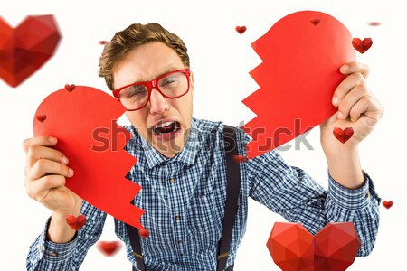 Geeky hipster holding a broken heart  Stock photo © wavebreak_media