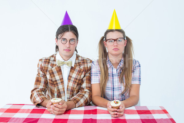 Unsmiling geeky hipsters celebrating birthday  Stock photo © wavebreak_media