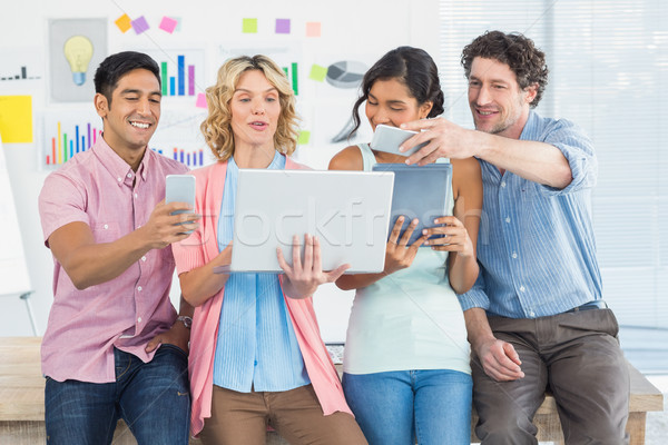 Casual businesspeople using digital tablet with colleagues behin Stock photo © wavebreak_media